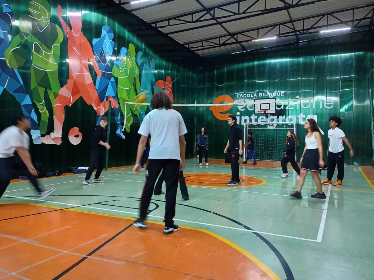 Alunos do Ensino Médio jogando vôlei na quadra poliesportiva coberta da Unidade II